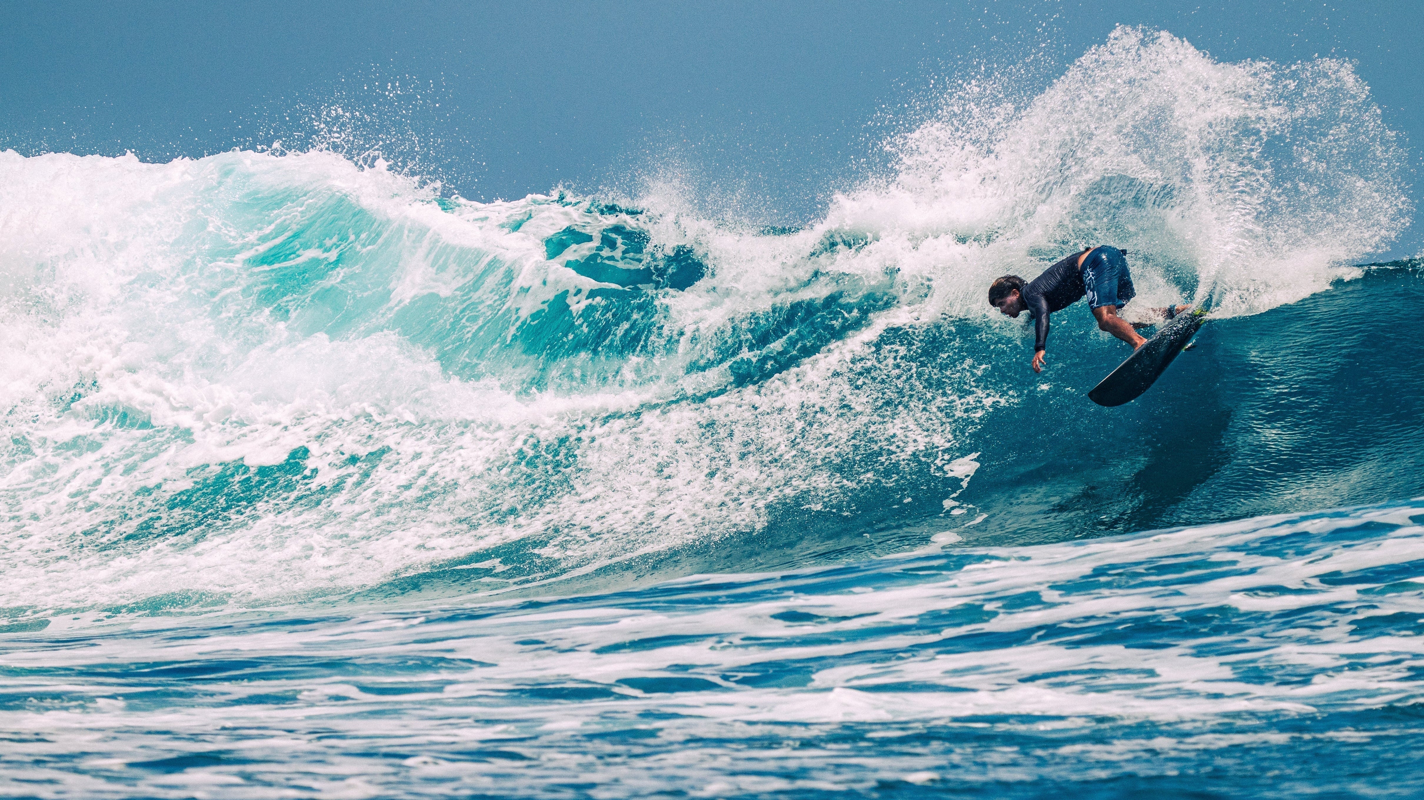 Surfer riding the Firewire Slater Designs Spaceship on a clean wave in Siargao.