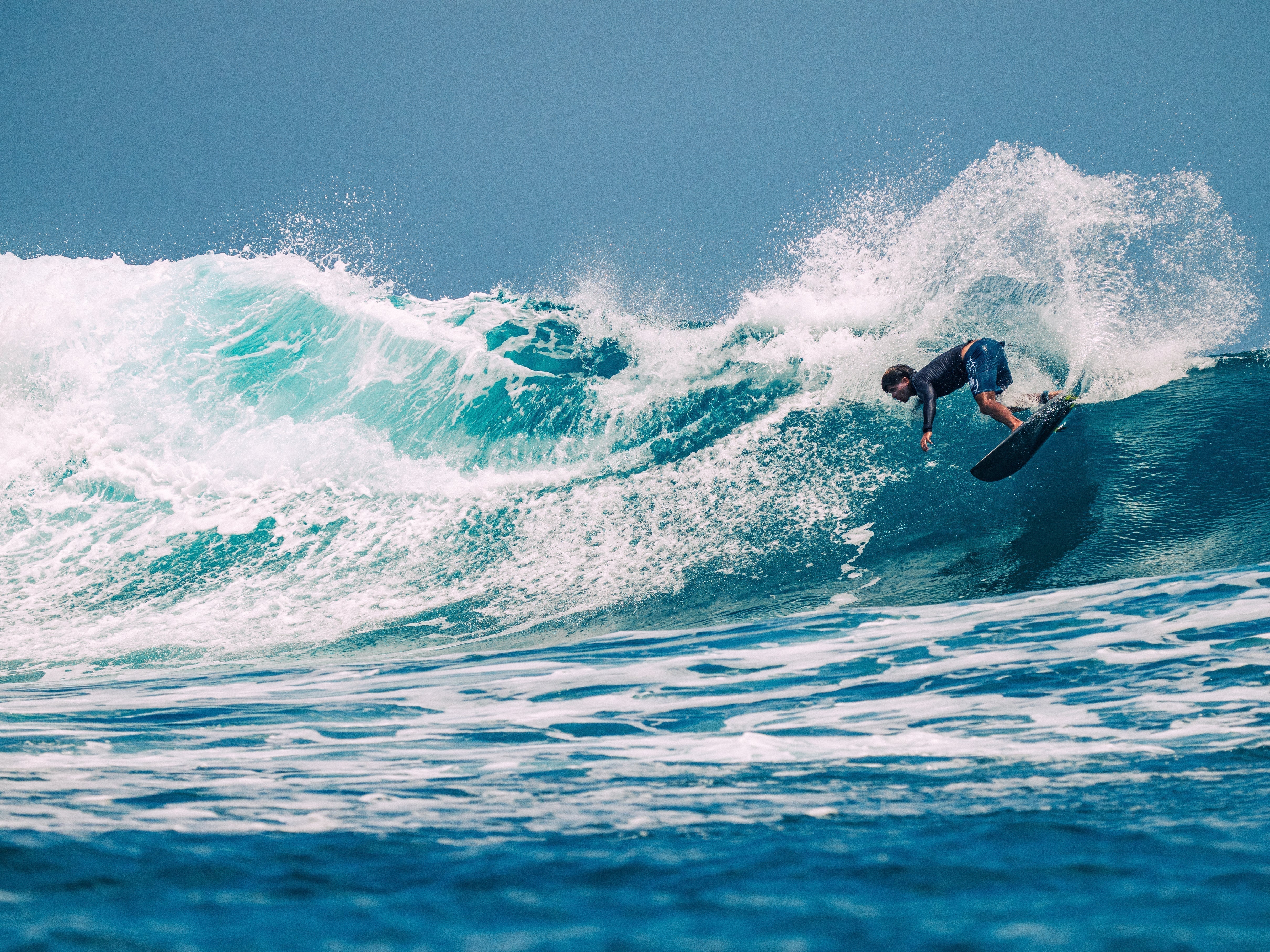 Surfer riding the Firewire Slater Designs Spaceship on a clean wave in Siargao.